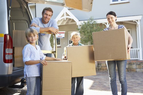 Family settling into a new home after house removals in Romford
