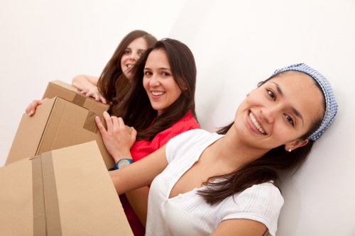 Family packing items for household storage in Romford